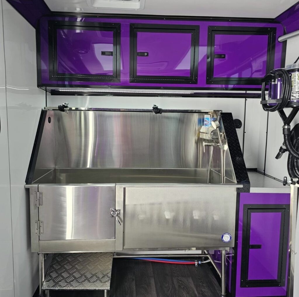 Stainless steel hydro bath inside the Lavish Licks grooming trailer