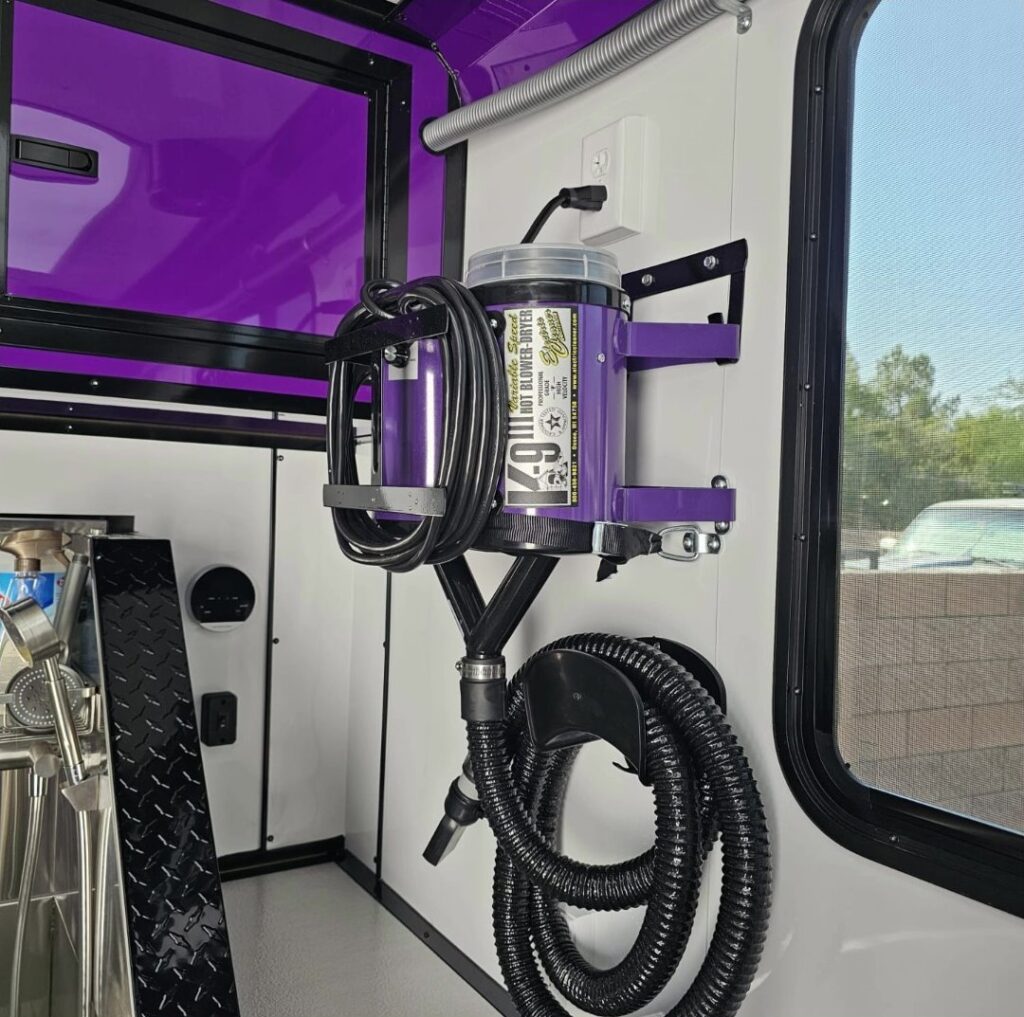 High-velocity dryer mounted inside the Lavish Licks grooming trailer